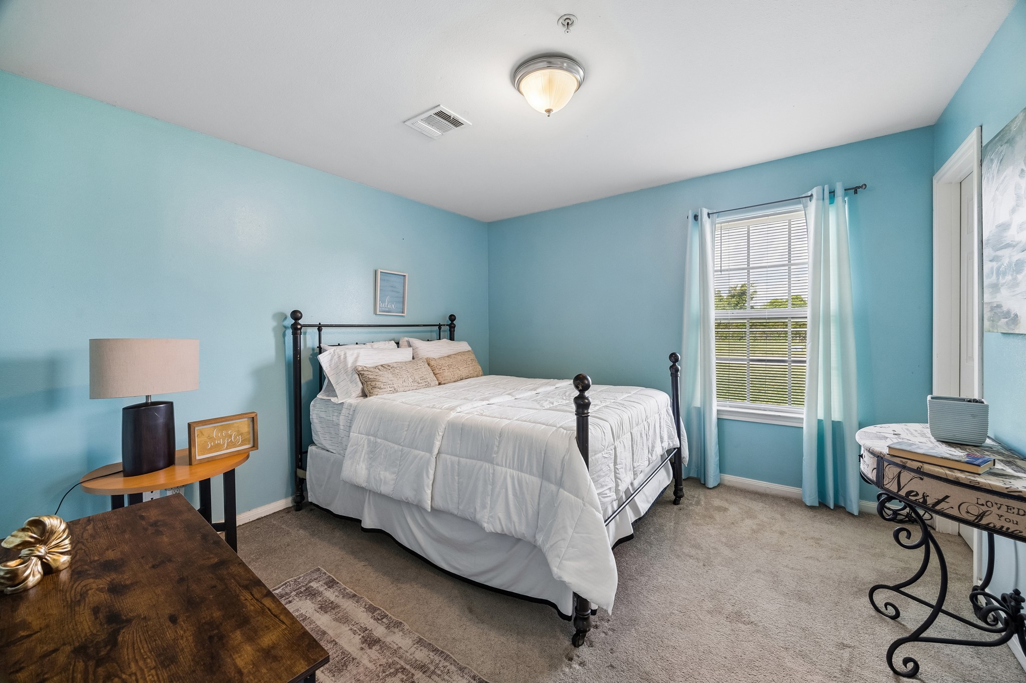 2013 Ellis School Road Baytown, TX 77521 - Photo 24 of 31 One of three spacious, well-proportioned bedrooms in each residence, offering a versatile layout with ample room for comfortable furnishings, a home-office setup, or additional guest accommodations. Thoughtfully furnished and move-in ready, this inviting retreat enhances the property’s polished, turn-key appeal for short-term guests or long-term residents.