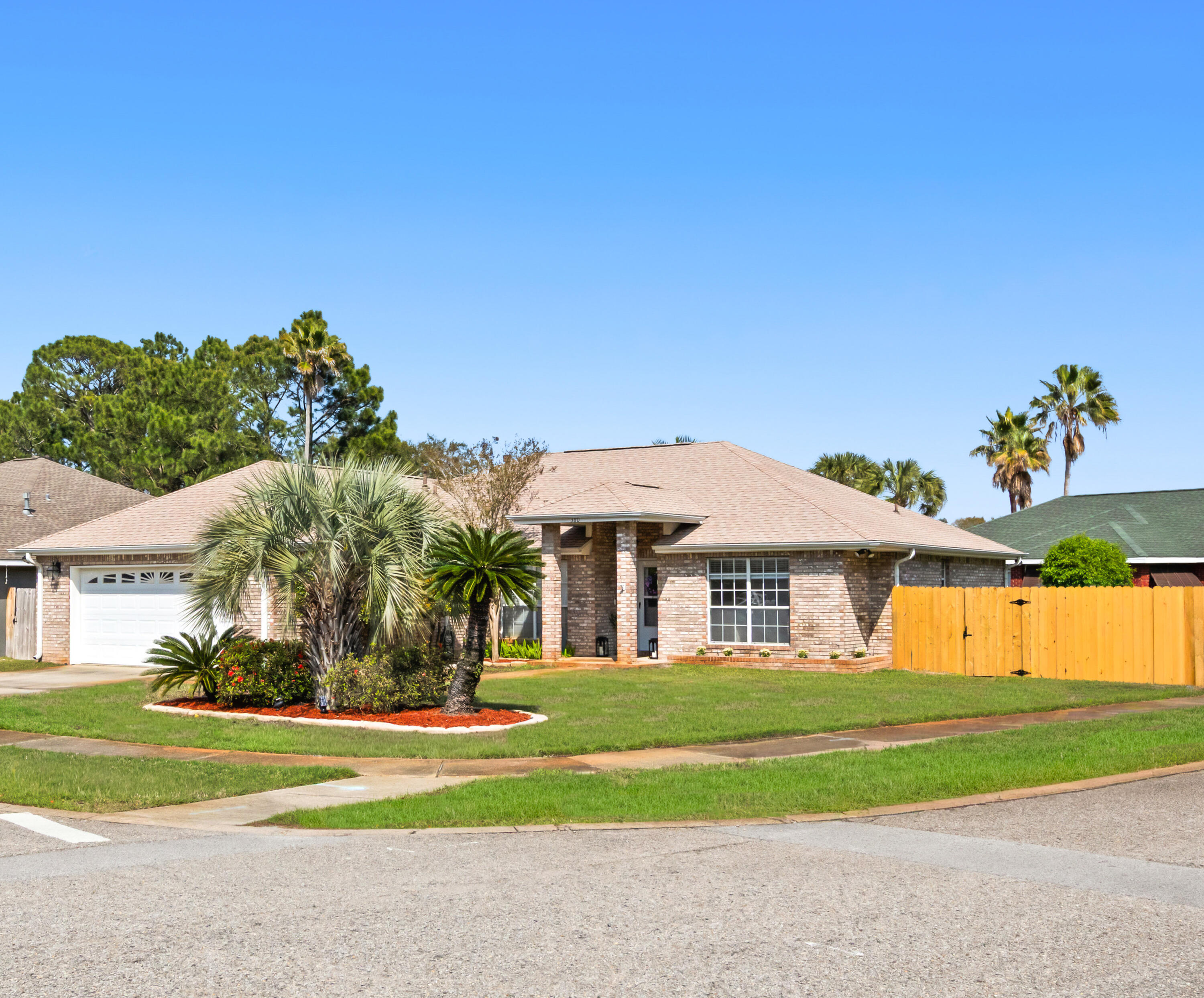 a front view of a house with a big yard
