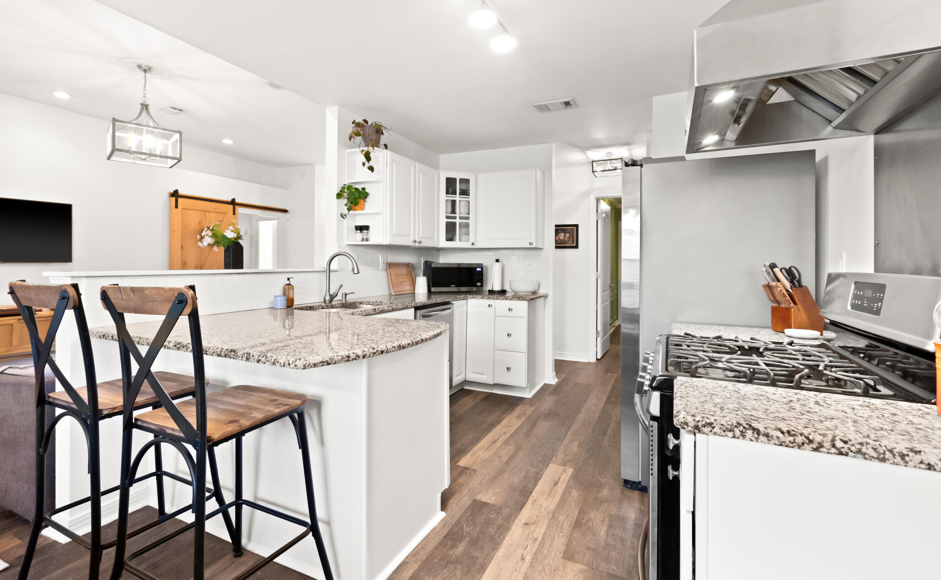 380 Sonora Road Destin, FL 32541 - Photo 20 of 62 a kitchen with stainless steel appliances granite countertop a stove top oven a refrigerator a sink and chairs