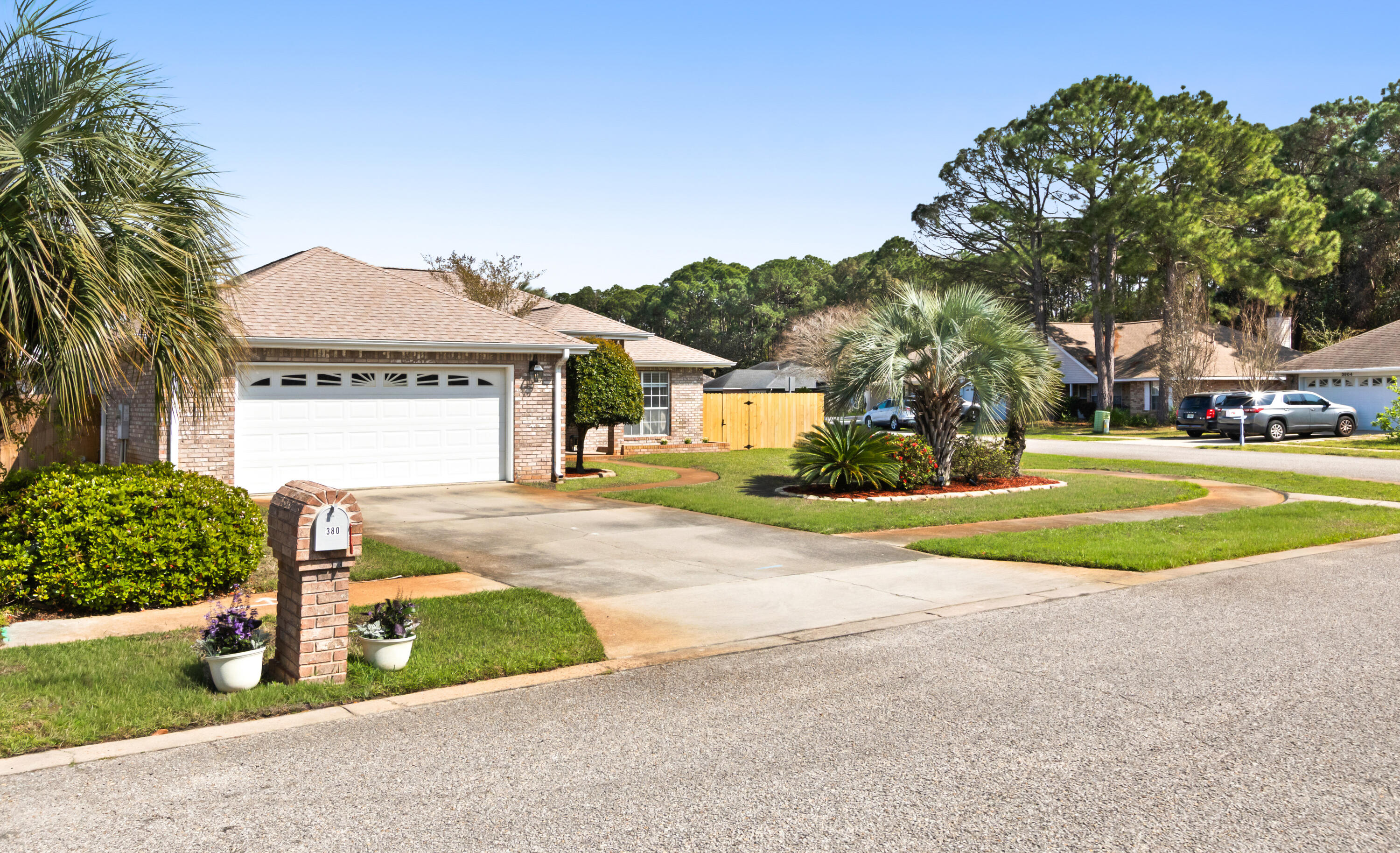 380 Sonora Road Destin, FL 32541 - Photo 2 of 62 a front view of a house with a yard and garage