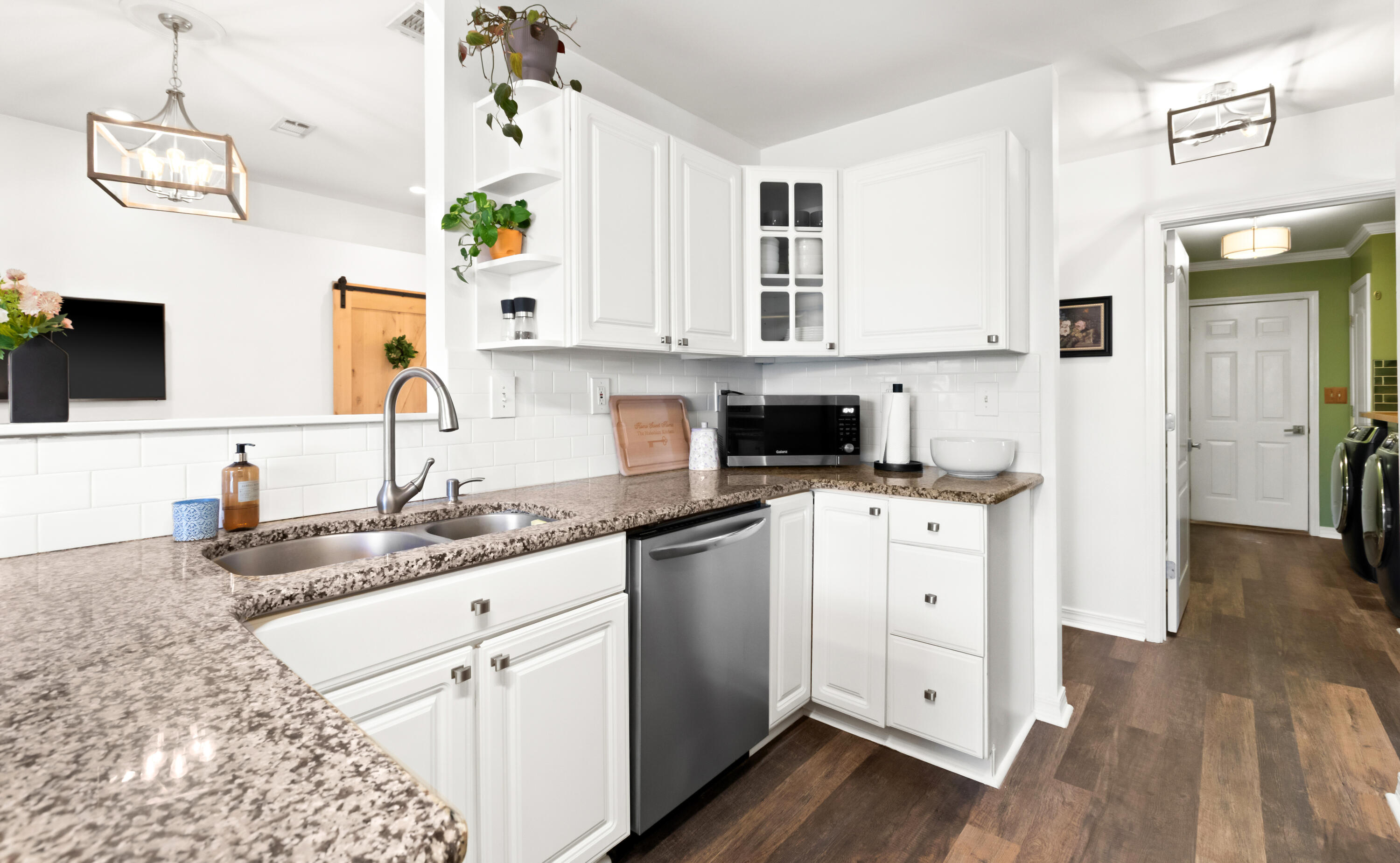380 Sonora Road Destin, FL 32541 - Photo 24 of 62 a kitchen with cabinets stainless steel appliances a sink and wooden floor