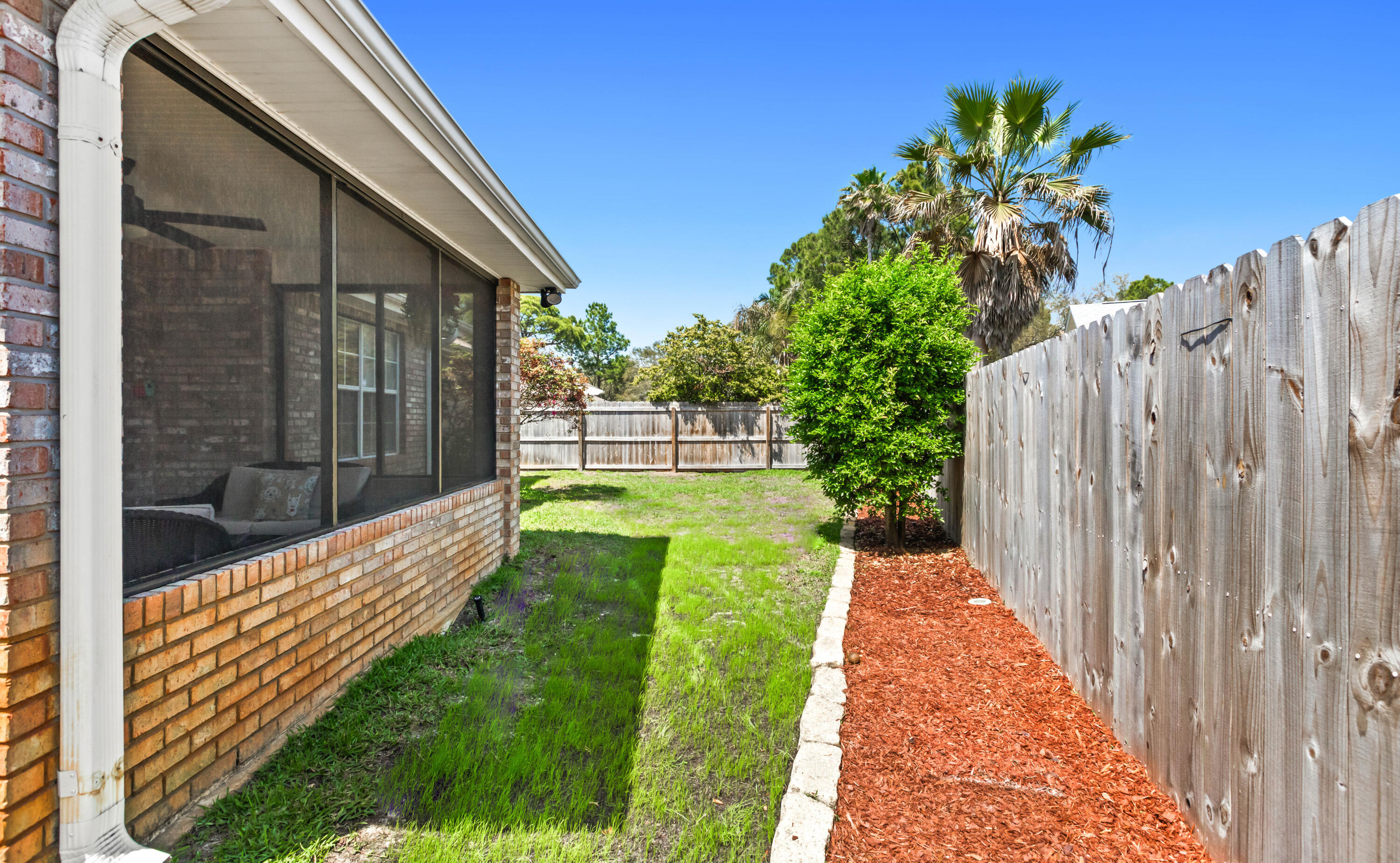 380 Sonora Road Destin, FL 32541 - Photo 56 of 62 a view of a house with a small yard and wooden fence