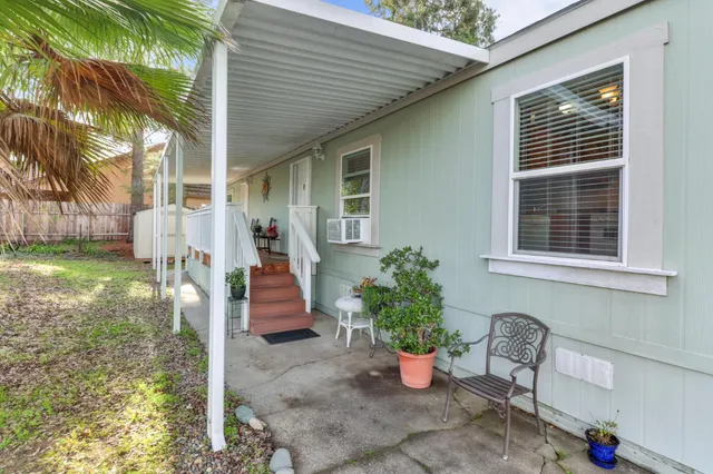 a view of a house with backyard and sitting area