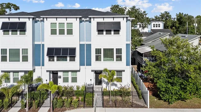 a front view of a building with a garden