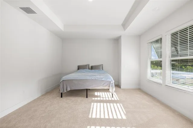 a bedroom with a bed and a rug