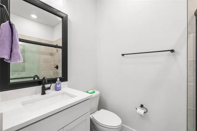 a bathroom with a sink a toilet and mirror