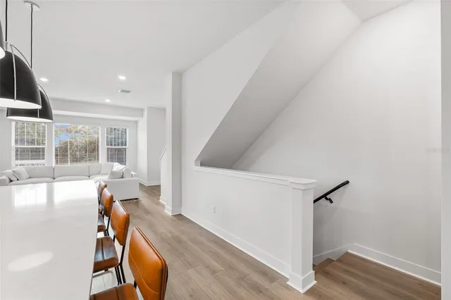 a view of a room with wooden floor and windows