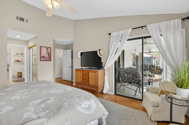 a bedroom with a bed a flat screen tv and a couch