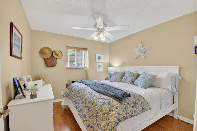 a bathroom with a granite countertop sink toilet a mirror a vanity and shower