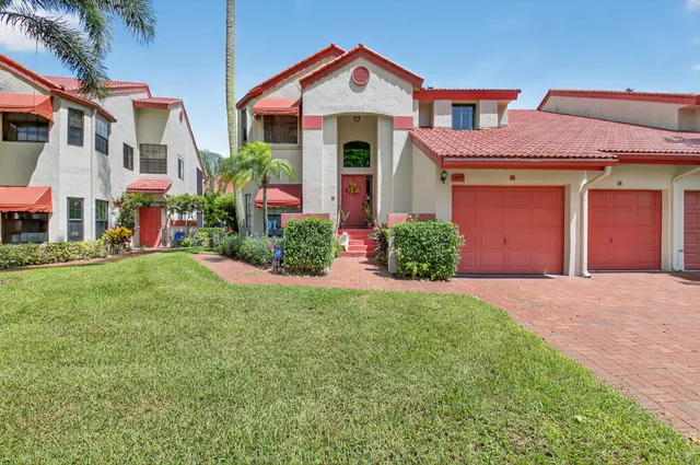 an aerial view of a house with a garden and lake view