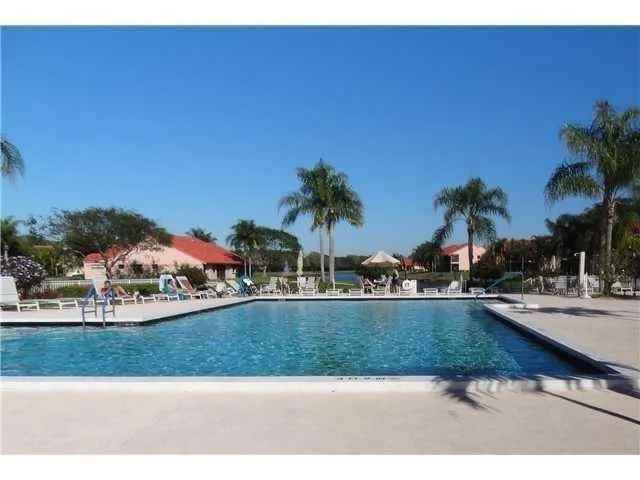 an aerial view of lake and residential houses with outdoor space