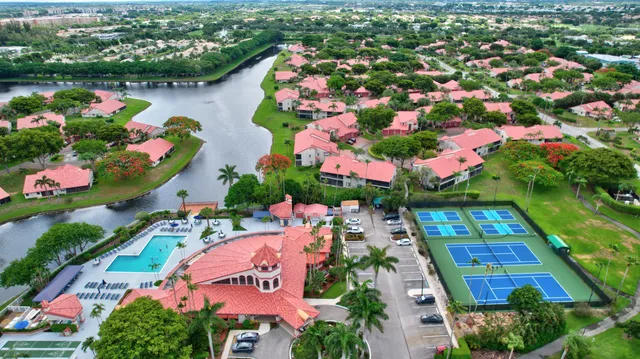 a living room with furniture a flat screen tv and kitchen view