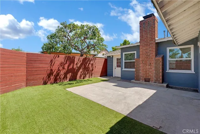 a view of a backyard with plants and a patio