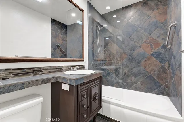 a bathroom with a sink a toilet and a bathtub