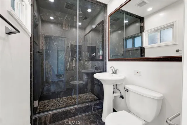 a bathroom with a sink toilet and shower