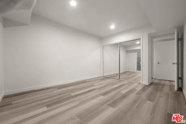 a view of an empty room and wooden floor