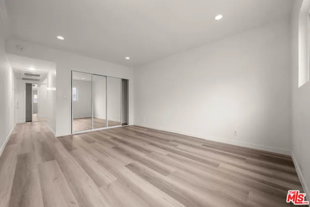a view of an empty room and wooden floor