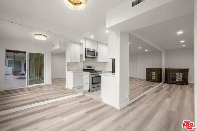 a view of kitchen with refrigerator microwave and stove