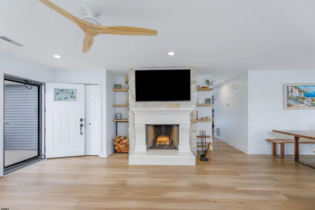 a living room with furniture a fireplace and a flat screen tv