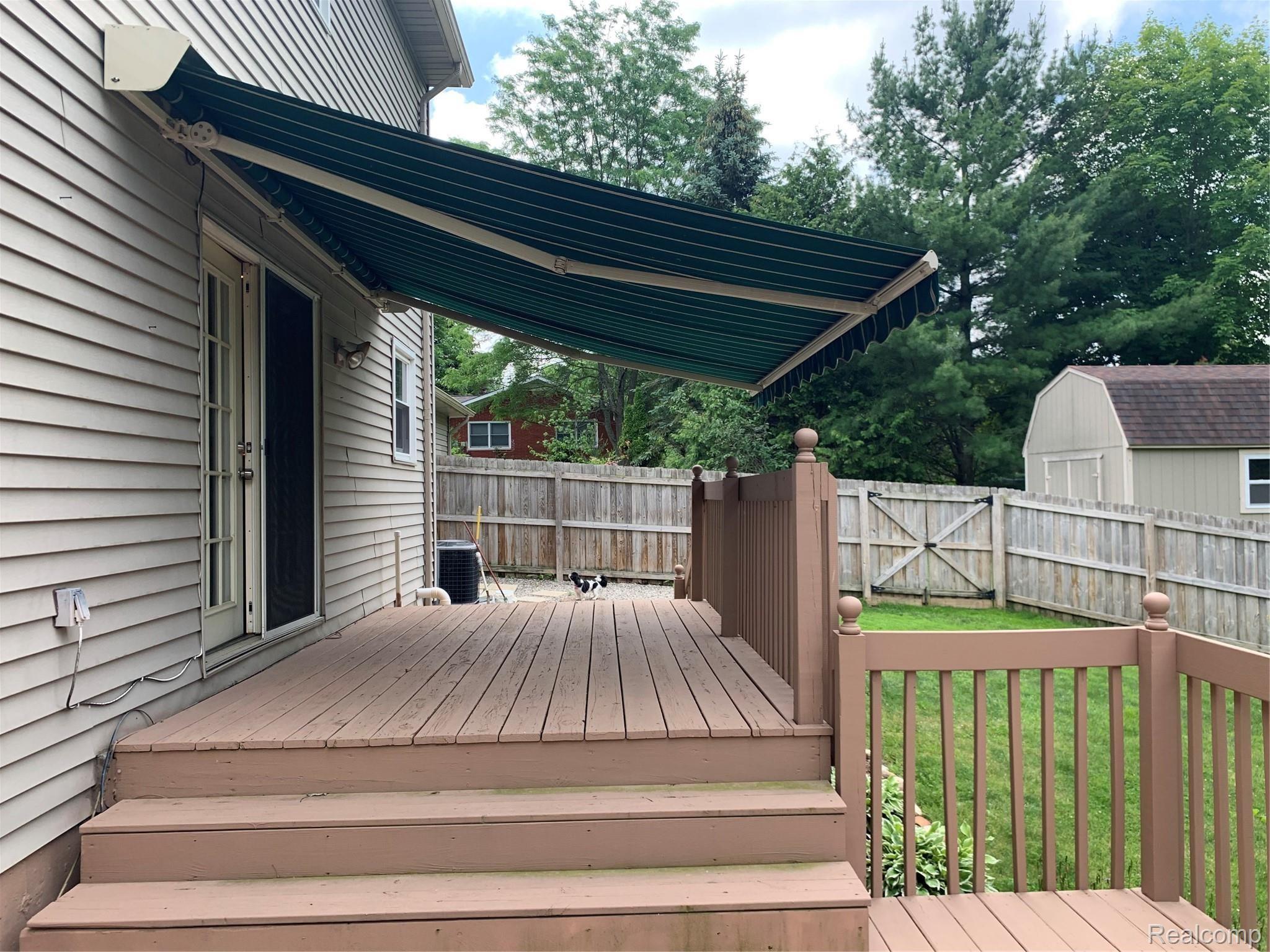 2525 Texter Road Leonard, MI 48367 - Photo 19 of 26 Awning Over Upper Deck-Enjoy the Shade!