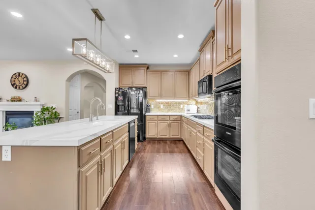 a kitchen with stainless steel appliances sink refrigerator and microwave