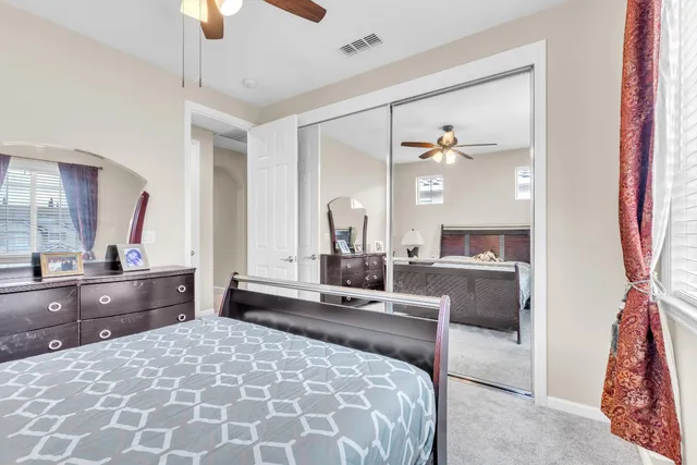 a bedroom with a large bed and a chandelier