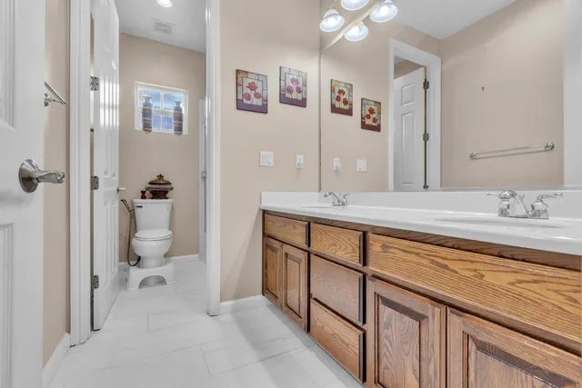 a spacious bathroom with a granite countertop sink toilet and shower