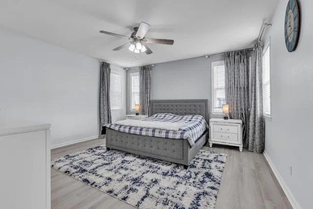 a bedroom with a bed and a chandelier