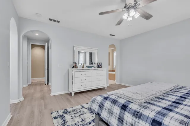 a bedroom with a bed and a dresser in it