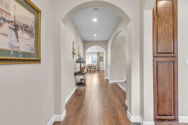 a view of a hallway view with wooden floor and staircase