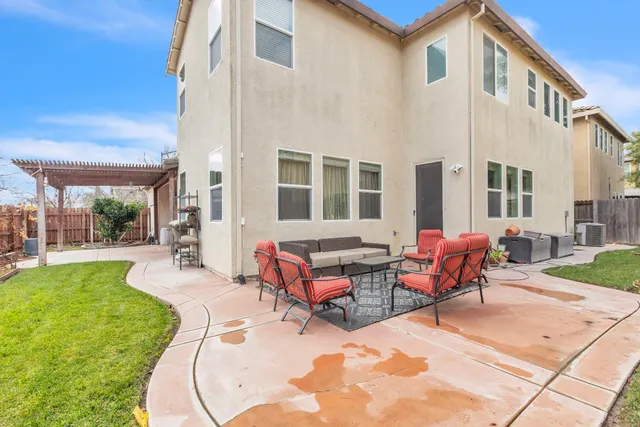 a backyard of a house with yard and outdoor seating