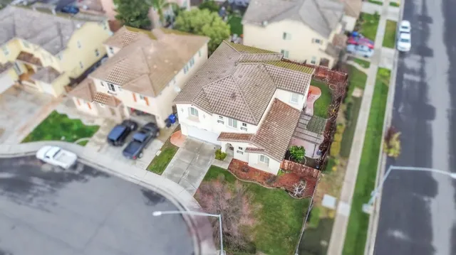 an aerial view of a house with a yard and garden