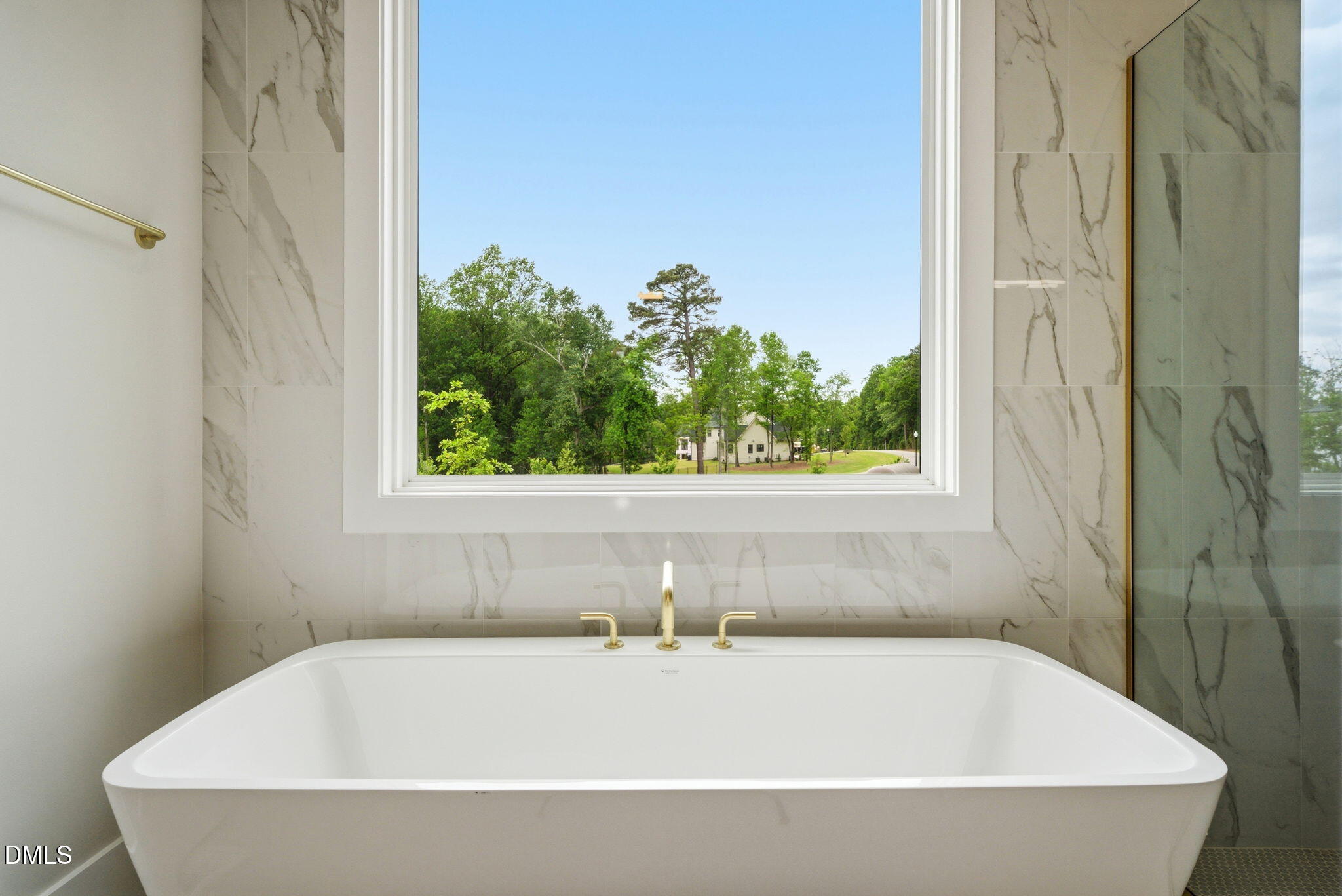 1304 Sanctuary Pond Drive Raleigh, NC 27606 - Photo 22 of 52 a white bath tub sitting in a bathroom next to a window
