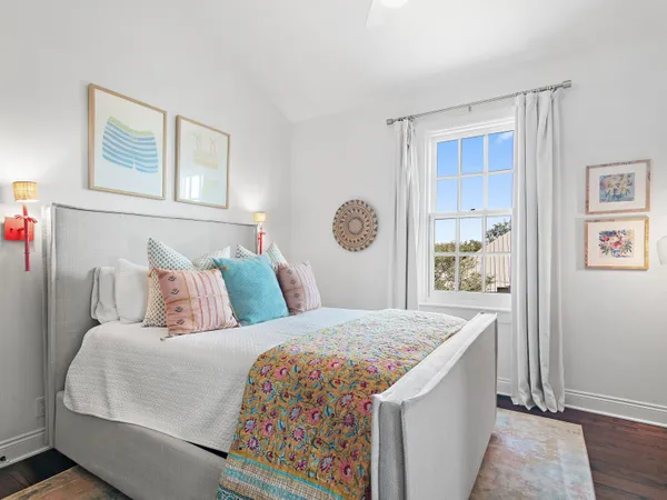 a bedroom with a bed and a painting on the wall