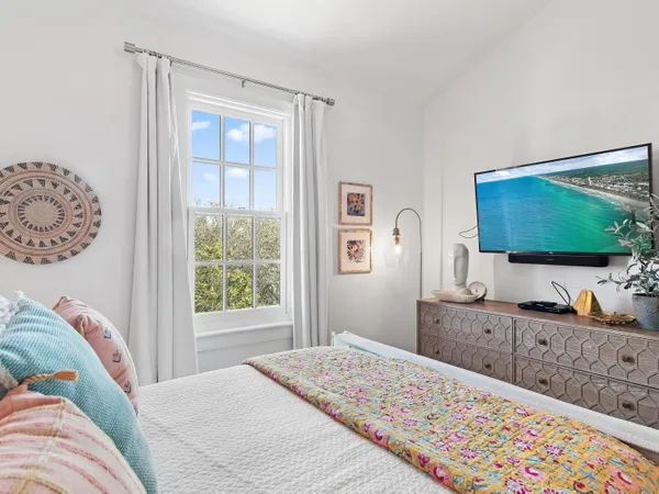 a bedroom with a bed and a flat screen tv