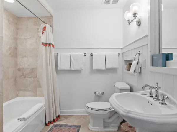 a bathroom with a sink a toilet and a bathtub