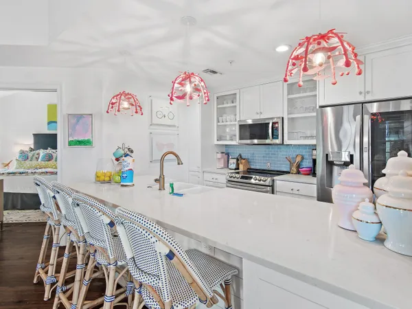 a kitchen with a white cabinets and chandelier