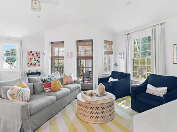 a living room with furniture and a potted plant
