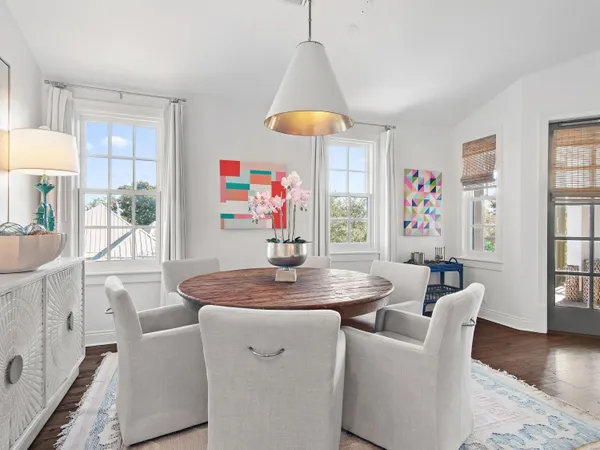 a dining room with furniture window and wooden floor