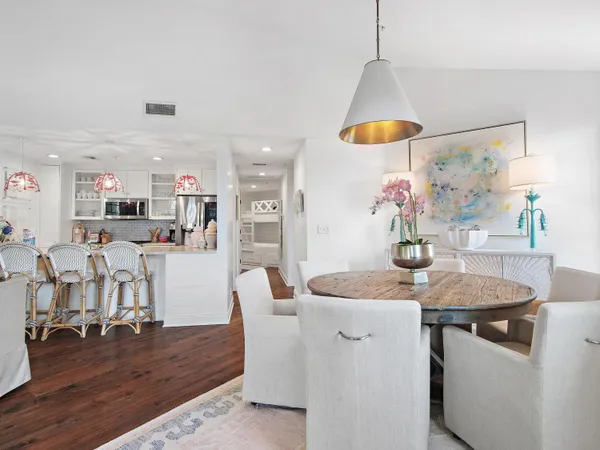 a dining room with furniture and wooden floor