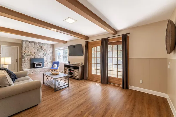 a living room with fireplace furniture and a large window