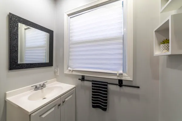 a bathroom with a sink mirror and toilet
