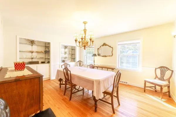 a kitchen with stainless steel appliances granite countertop a dining table and chairs