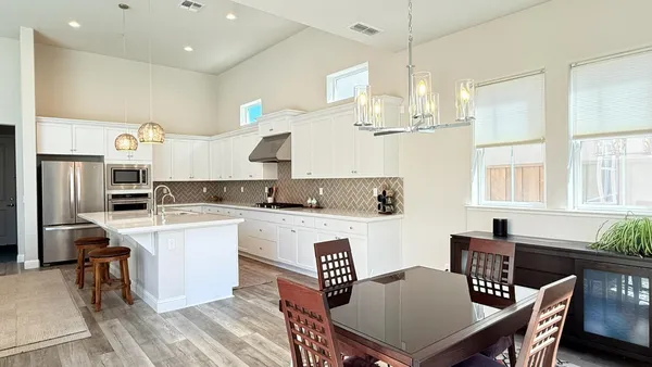 a kitchen that has a table and chairs in it