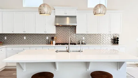 a kitchen with a sink a counter space and cabinets