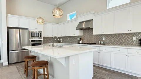 a kitchen with stainless steel appliances a sink stove and refrigerator