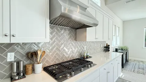a kitchen with a sink a stove and cabinets