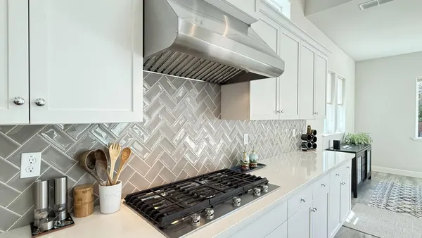 a kitchen with a sink a stove and cabinets