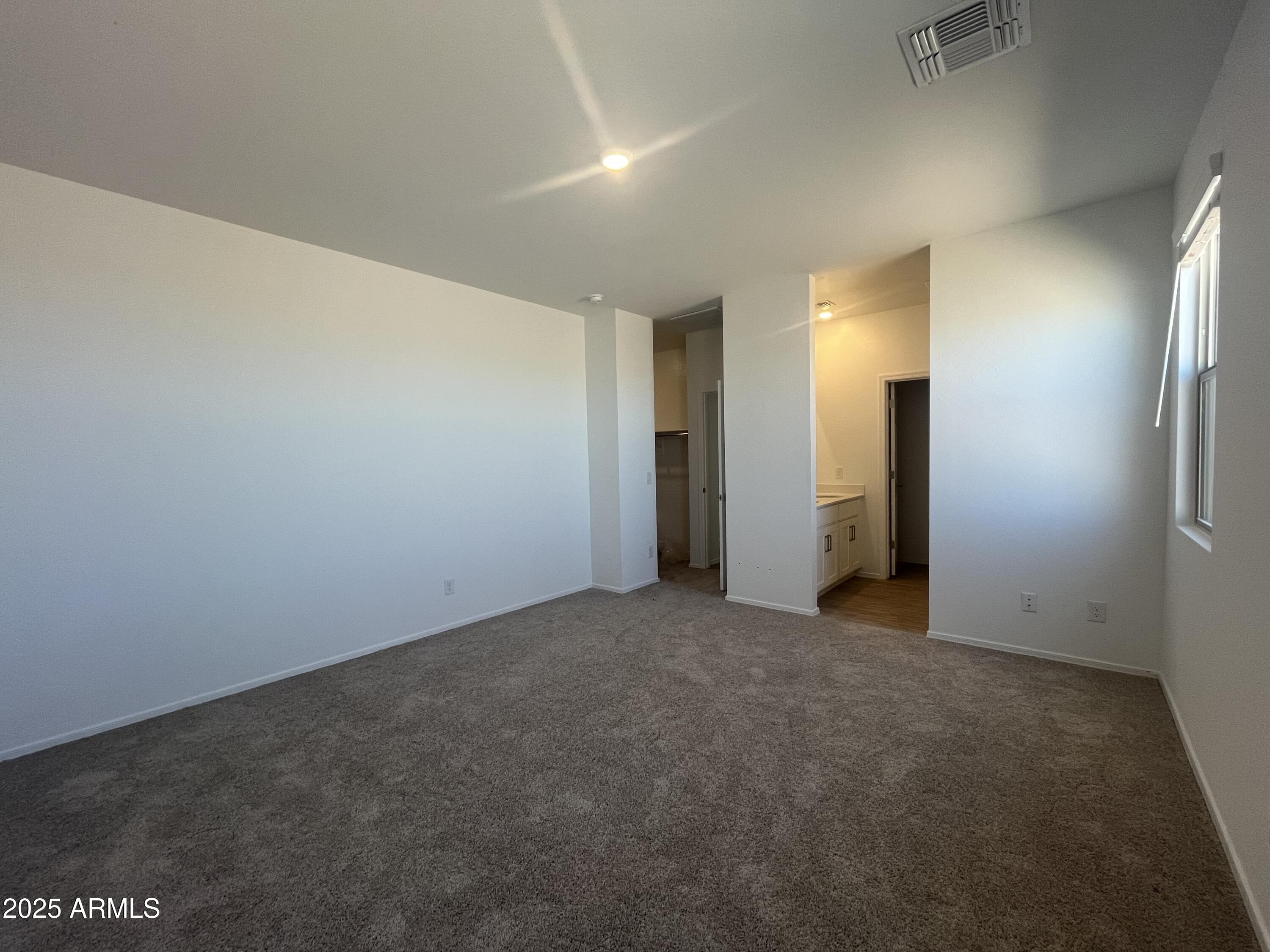 47692 West Moeller Road Maricopa, AZ 85139 - Photo 17 of 31 an empty room with closet and mirror