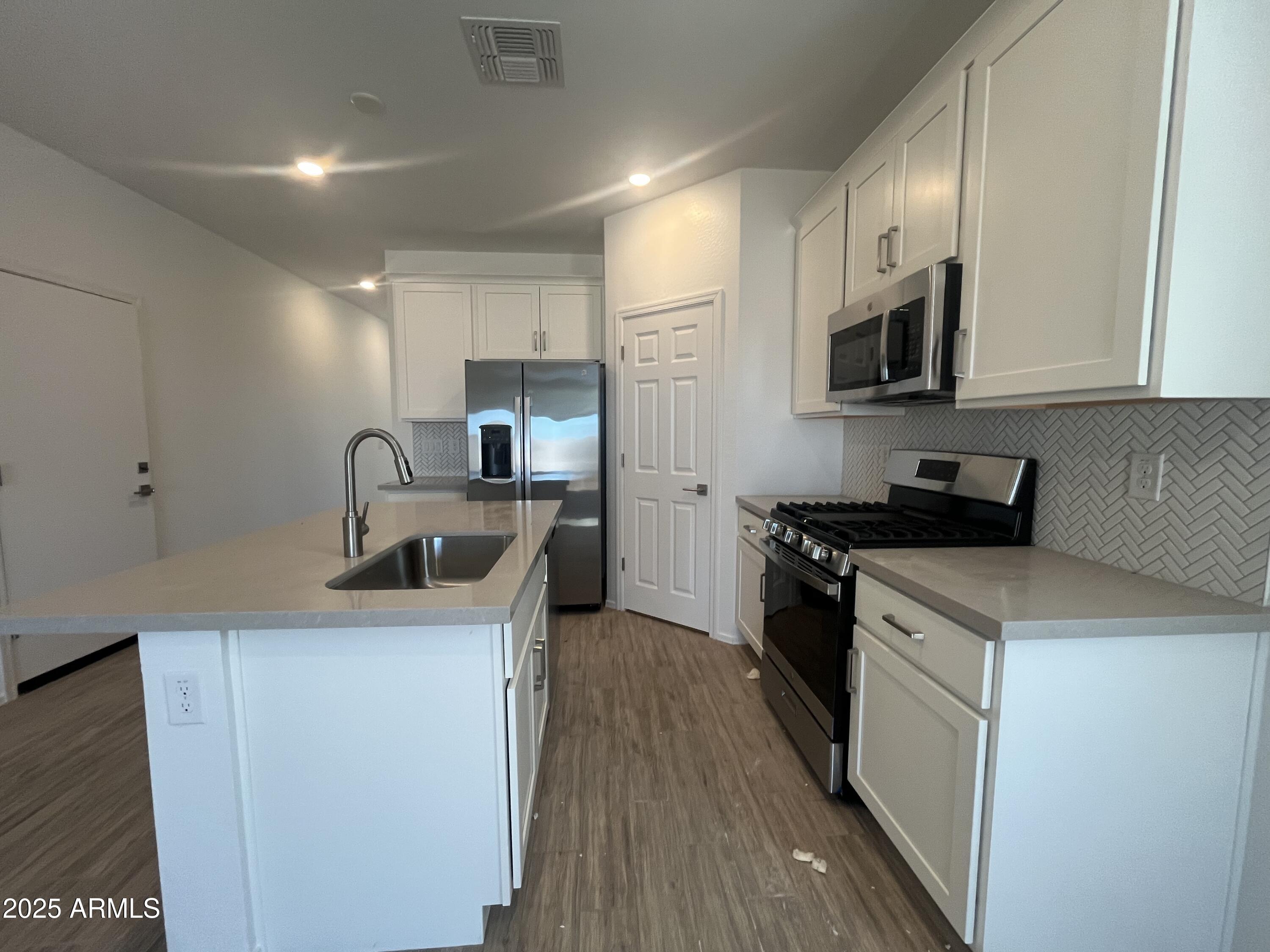 47692 West Moeller Road Maricopa, AZ 85139 - Photo 8 of 31 a kitchen with stainless steel appliances a sink stove and refrigerator